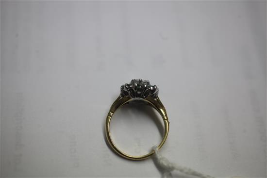 A 1980s 18ct gold, diamond and emerald cluster ring, size L.